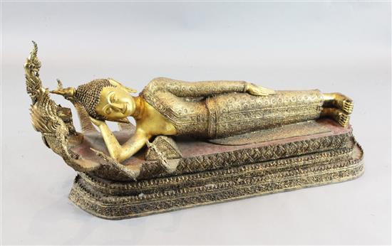 A large Thai gilt and polychrome bronze reclining figure of Buddha, possibly Mandalay period, 19th century, length approx. 132cm, heigh